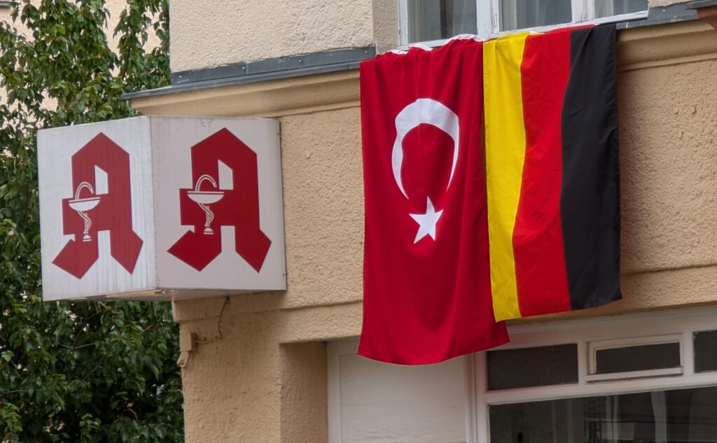 Turkish and German flags on Berlin building during UEFA Euro 2024.